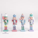 Set of four pastel nutcracker figurines holding candy themed accessories shown with a 5 inch height and 1.375 inch base width.