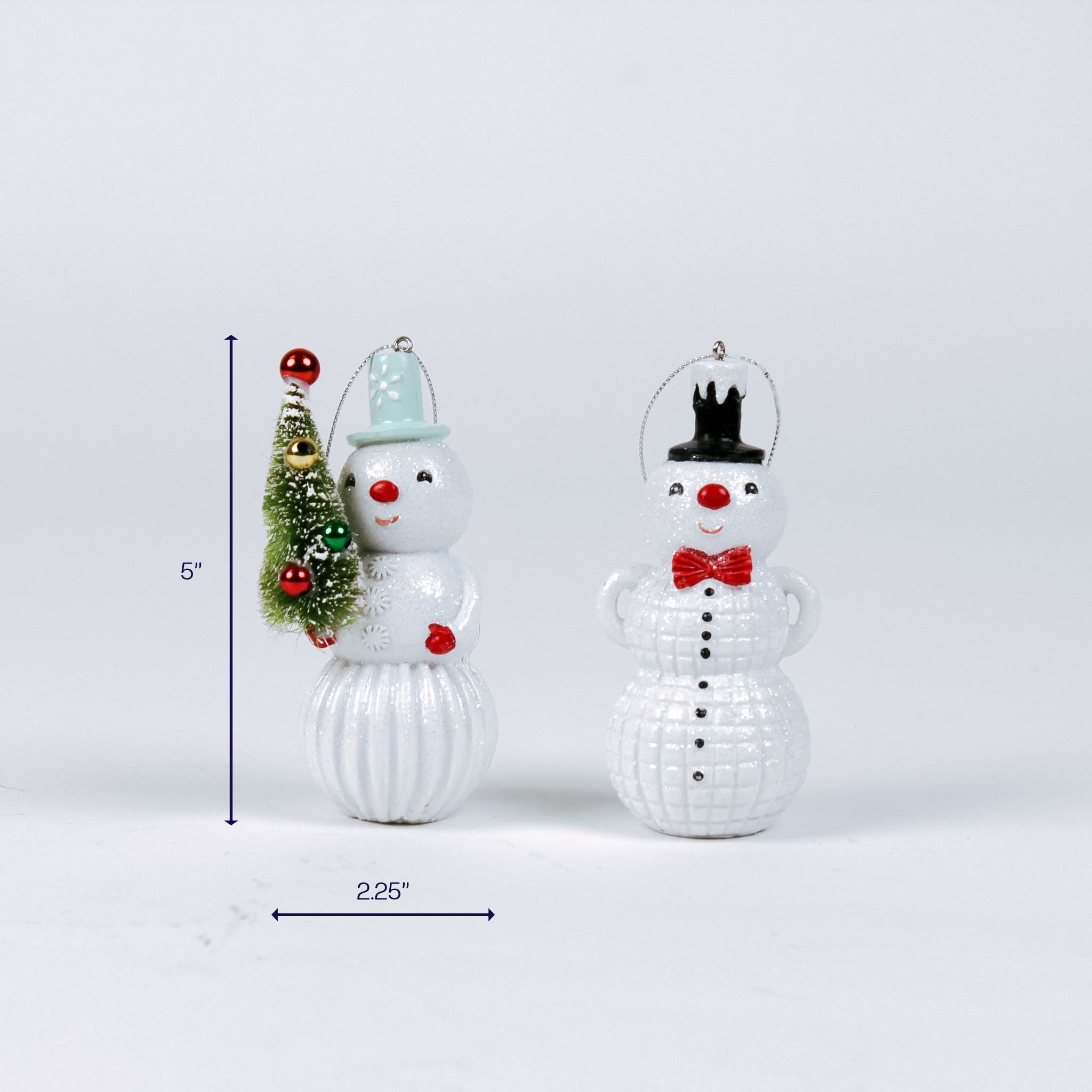 Two white snowman ornaments with hats and a tree, measuring about 5 inches tall and 2.25 inches wide.