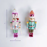 Set of two colorful nutcracker Christmas ornaments with candy themed details shown with 7 inch height and 2 inch width.