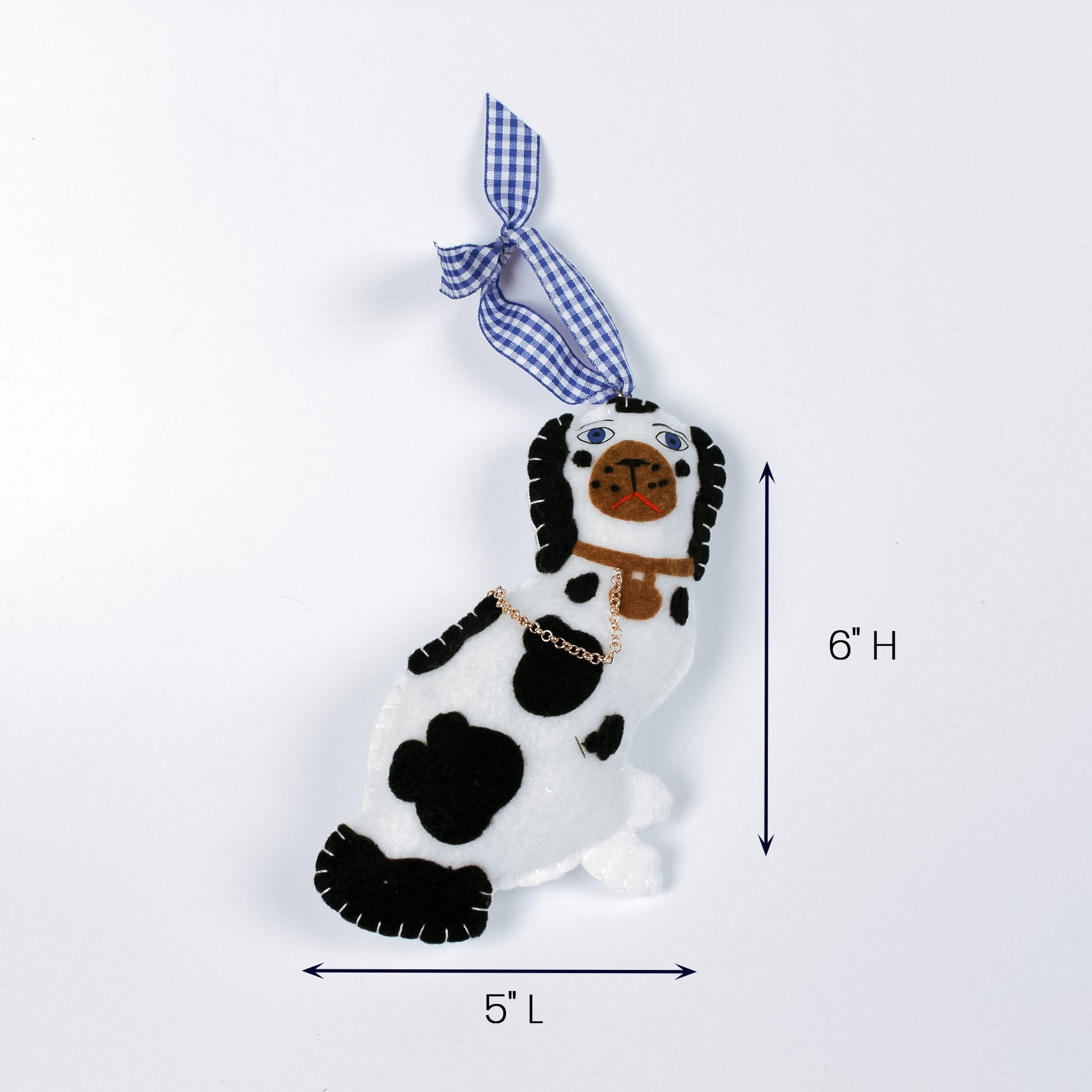 felt dog ornament with black spots and blue gingham hanging ribbon.