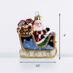 Colorful Santa sleigh Christmas ornament with presents and a snowman shown with 3.5 inch width and 4 inch height.