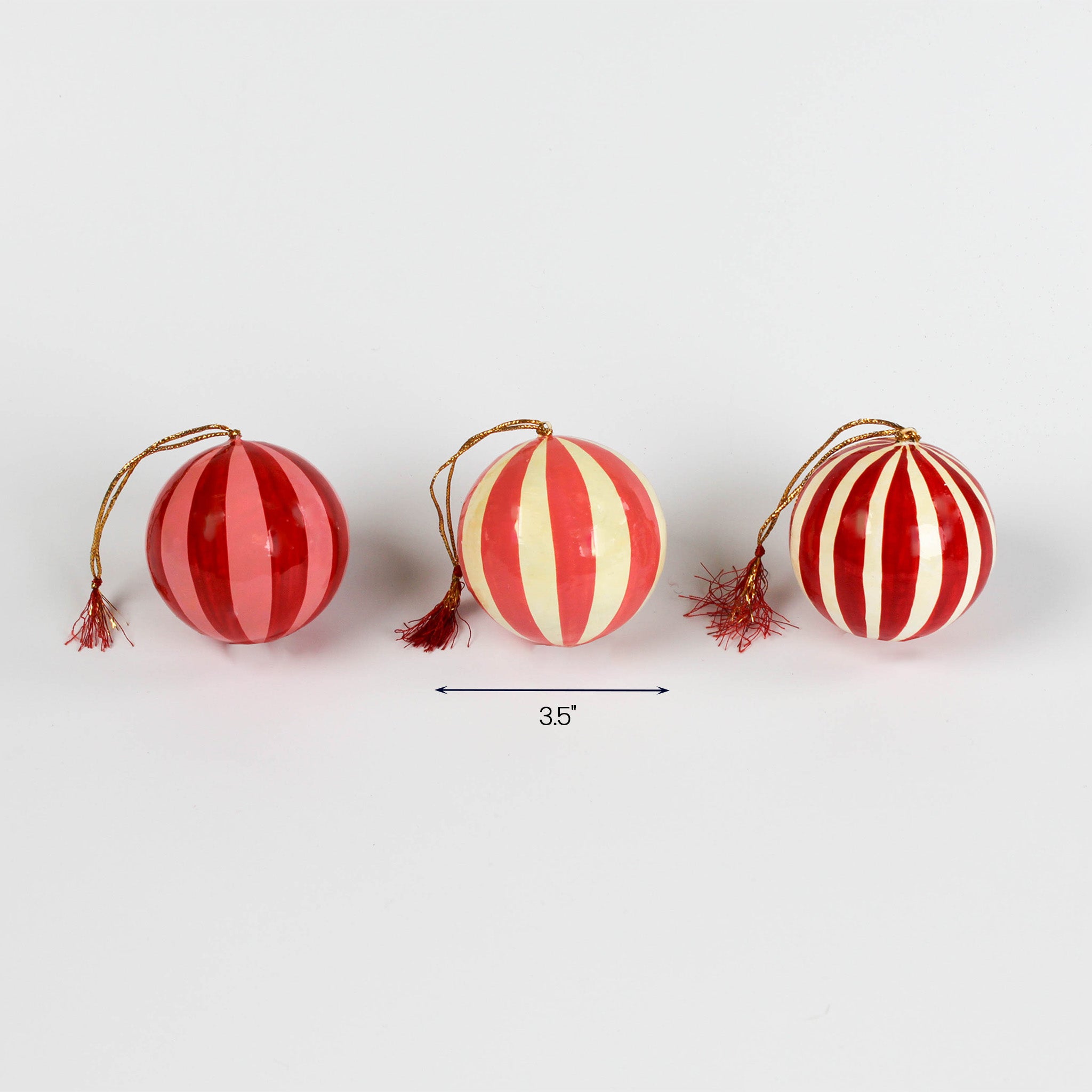 Three red striped spherical Christmas ornaments with gold hanging cords and tassels, each about 3.5 inches wide.