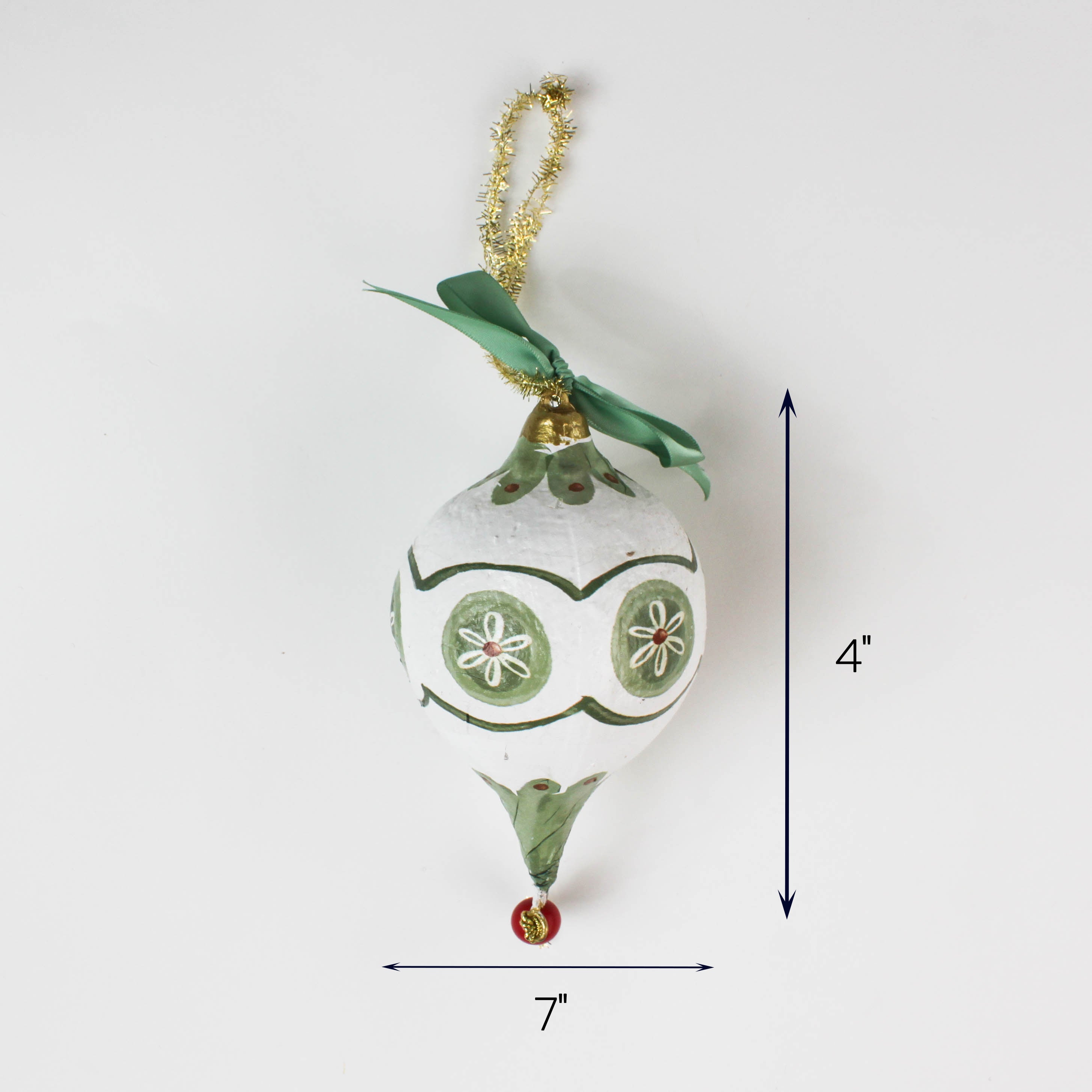 Green and white Christmas ornament with bow and gold hanger, measuring 4 inches tall and 7 inches wide.