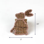 Woven rattan bunny-shaped napkin ring with pink trim, measuring approximately 4.5 inches tall and 3 inches wide.