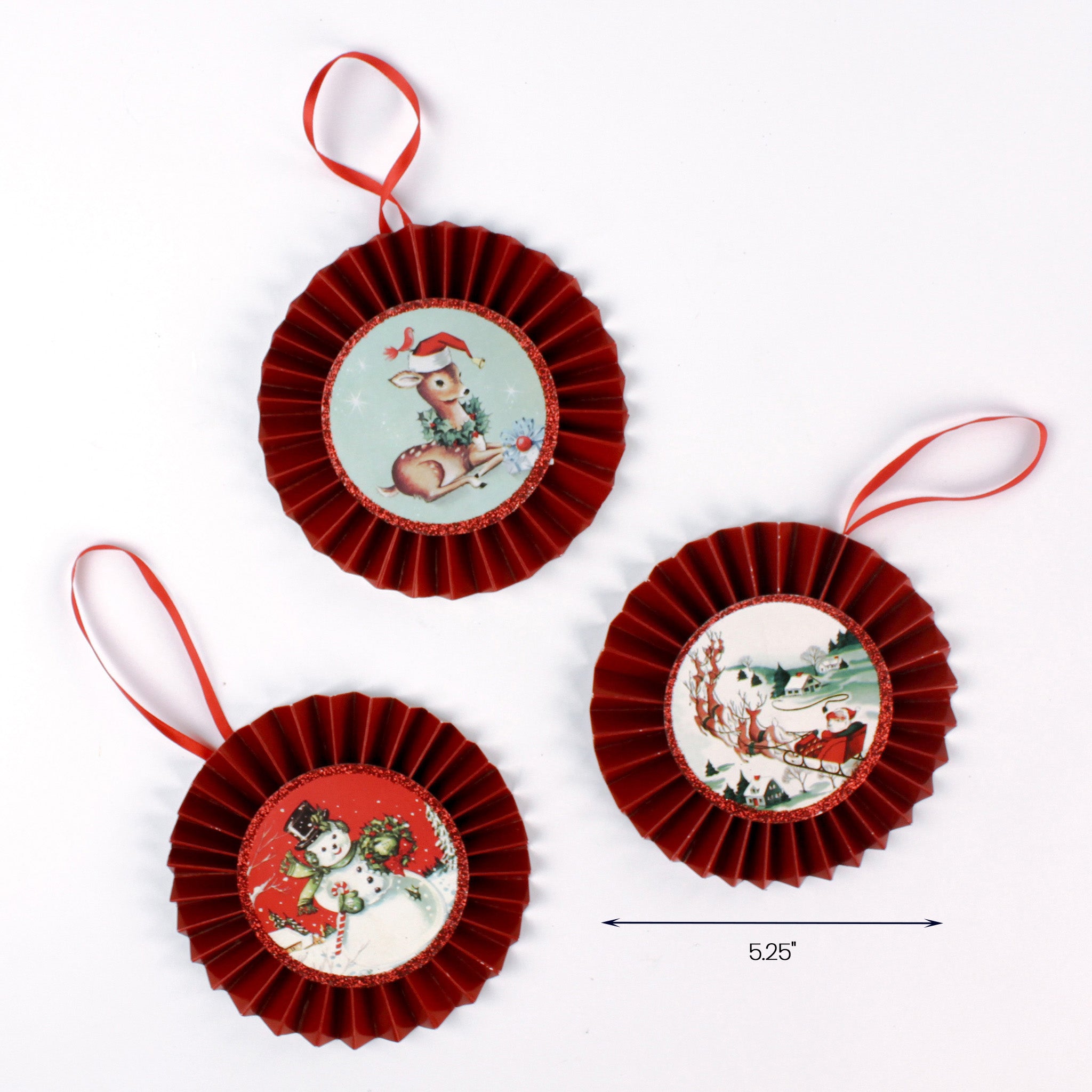 Set of three vintage-style Christmas rosette ornaments with red pleated edges and illustrated centers featuring a deer, snowman couple, and Santa in a sleigh, each with a red hanging ribbon. Approximate width: 5.25 inches.