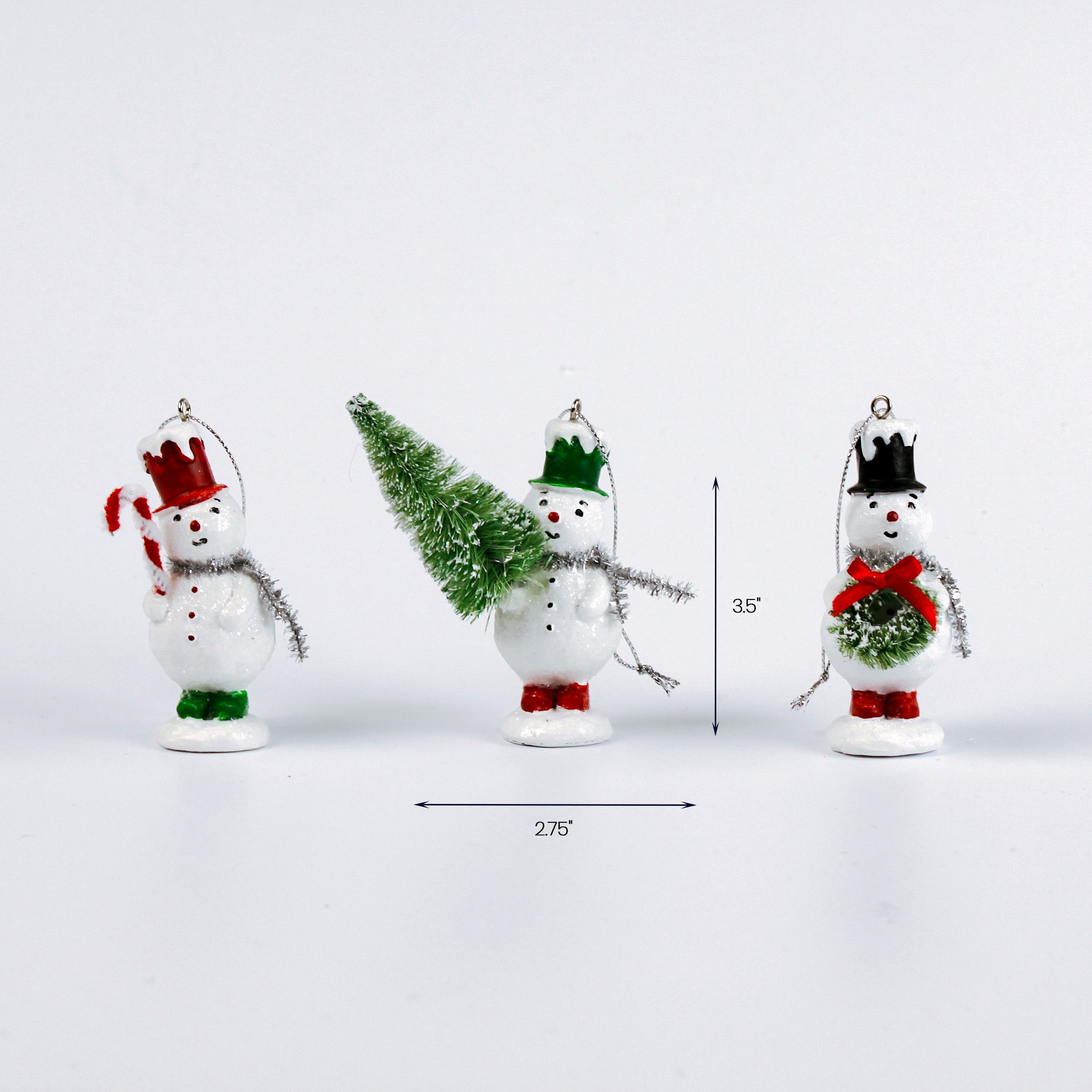 Three small snowman ornaments standing in a row, each with different hats and decorations, with measurement arrows showing their height of 3.5 inches and the center ornament width of 2.75 inches.