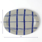 Oval ceramic serving platter with hand-painted blue grid pattern, 14.25 inches long and 10.375 inches wide.