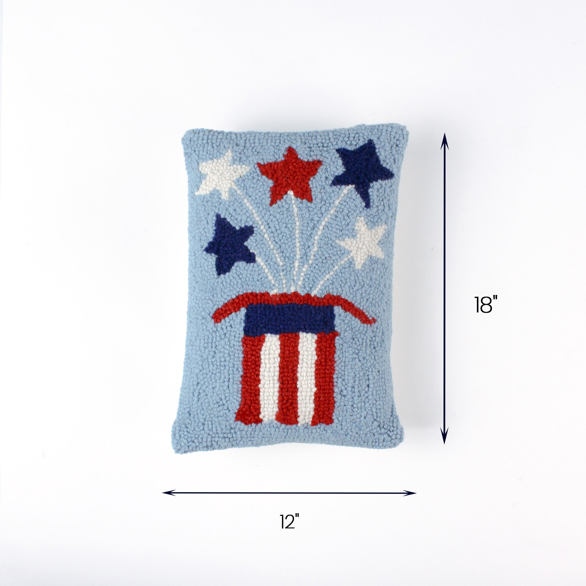 Light blue rectangular pillow with red, white, and blue starburst design and an American flag–themed base, measuring 18 inches high and 12 inches long.