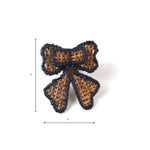 Woven rattan bow ornament with navy trim measuring 4 inches tall and 3 inches wide.
