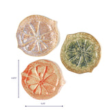 Set of three ceramic sand dollar shaped plates in blue green and coral tones shown with one measuring about 6.875 inches tall and 6.25 inches wide.