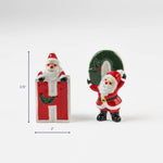 Two ceramic Santa figurines forming the letters H and O, approx. 3.75 inches tall and 2 inches wide.
