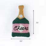 Christmas tea towel cheers bottle pillow, green and pink, 15.5 inches long and 3.5 inches high.