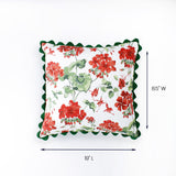 Square pillow with red and green floral pattern and scalloped green edges shown with 19 inch length and 8.5 inch width.