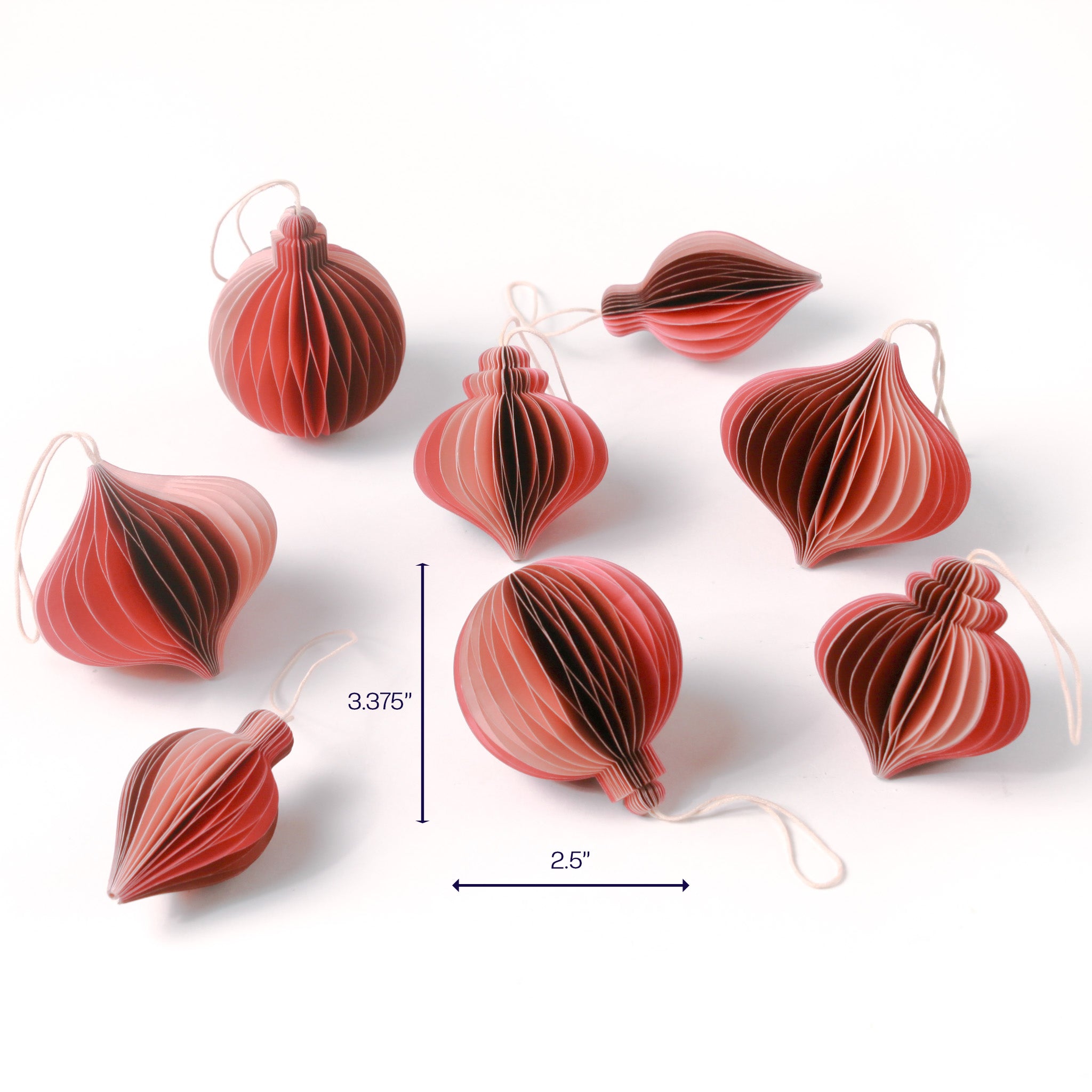 Set of red paper honeycomb Christmas ornaments in assorted shapes shown with one ornament measuring about 3.375 inches tall and 2.5 inches wide.
