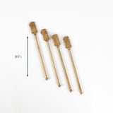 Set of four gold pineapple drink stirrers, 8.5 inches long.