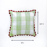 Square pillow with green plaid design and red scalloped edges shown with 19 inch length and 8.5 inch height.
