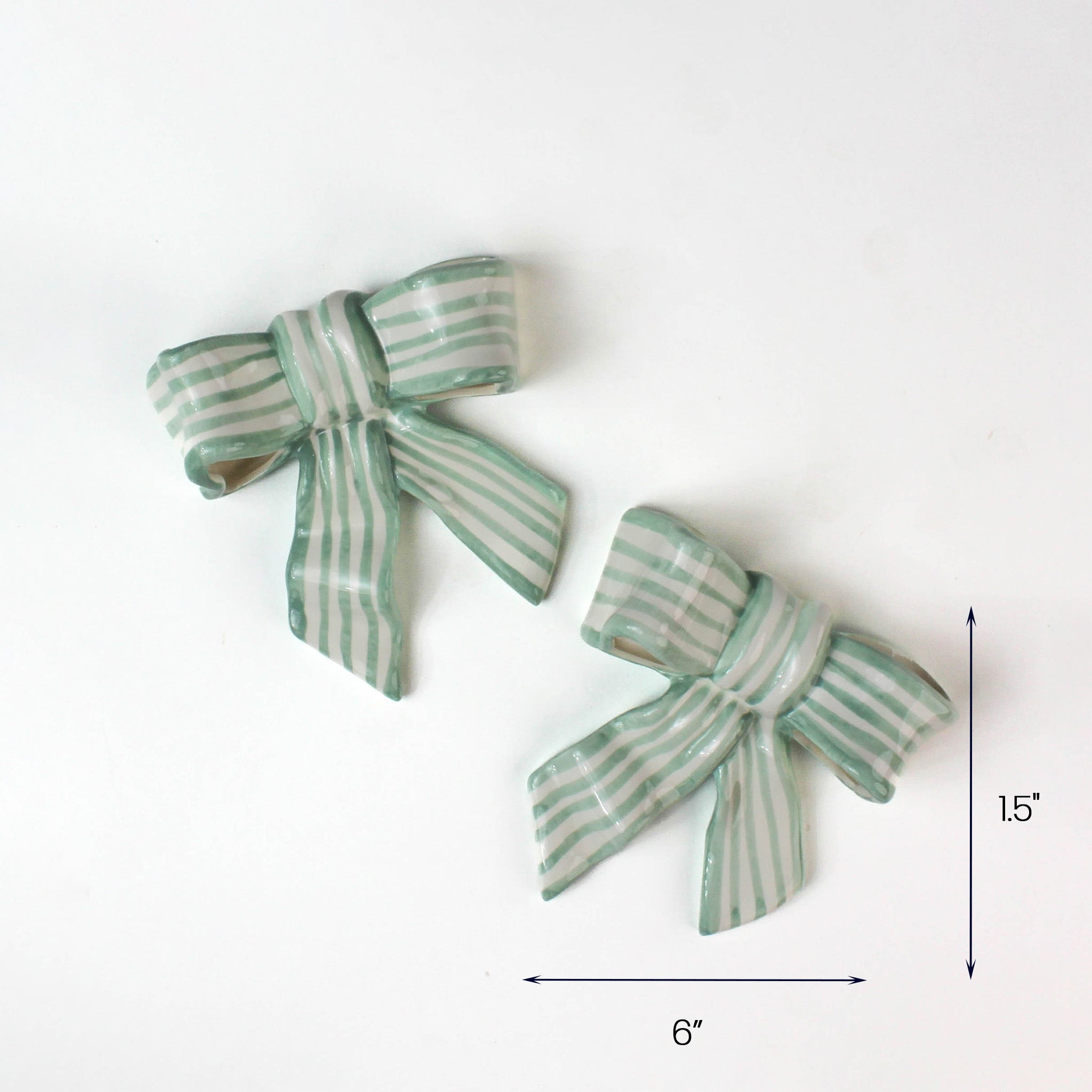 Set of two green striped ceramic bows, each 6 inches wide.