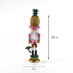 Christmas nutcracker figurine with gold pineapple hat, pink outfit, standing 20 inches tall.