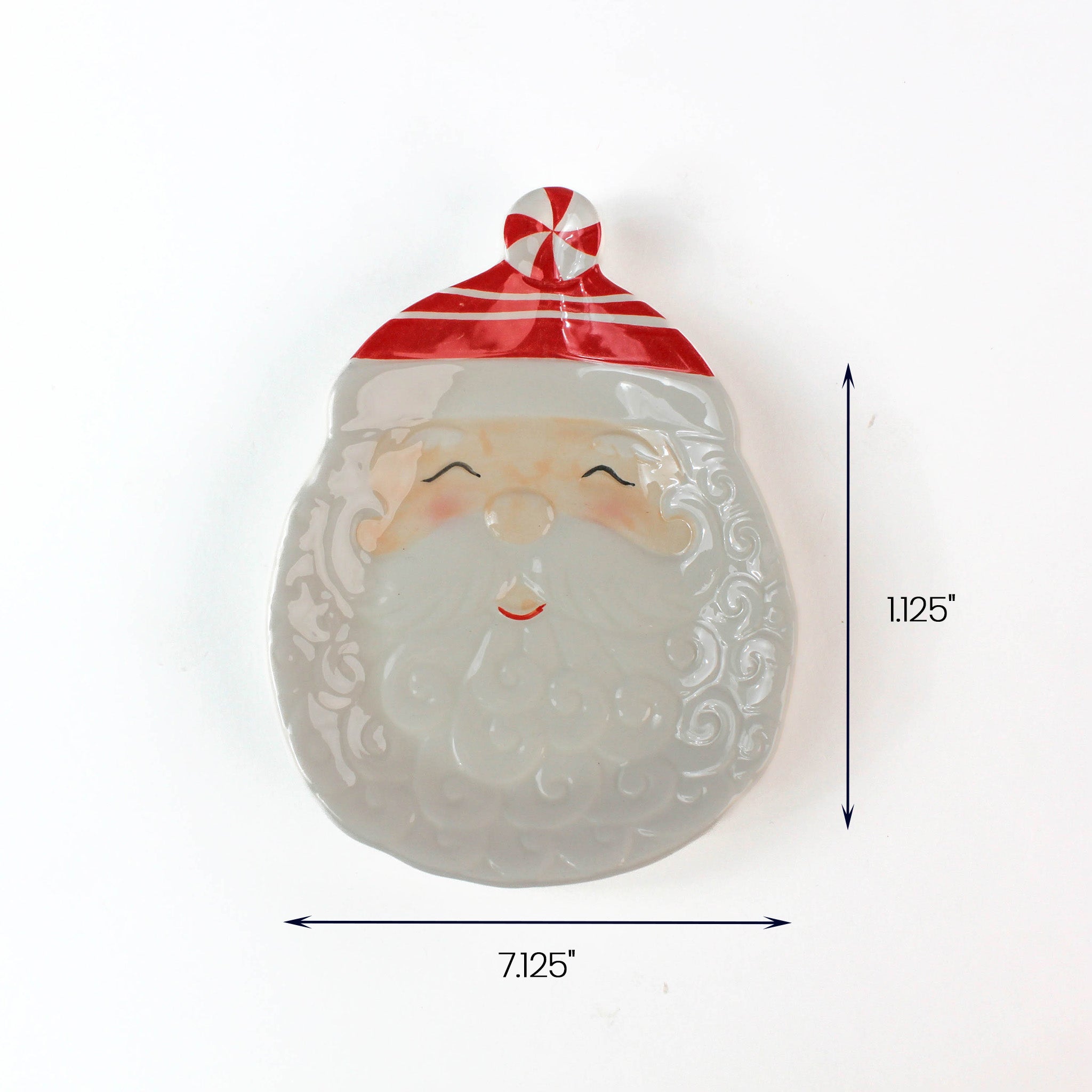 White ceramic Santa-shaped dish with a red-striped hat, shown with measurements of 7.125 inches wide and 11.25 inches tall.