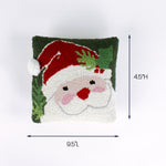 Square pillow with a Santa face design and green background shown with 9.5 inch length and 4.5 inch height.