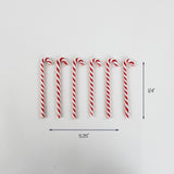 Set of seven red and white striped candy cane ornaments arranged in a row, each measuring approximately 5.25 inches long and 0.25 inches wide.