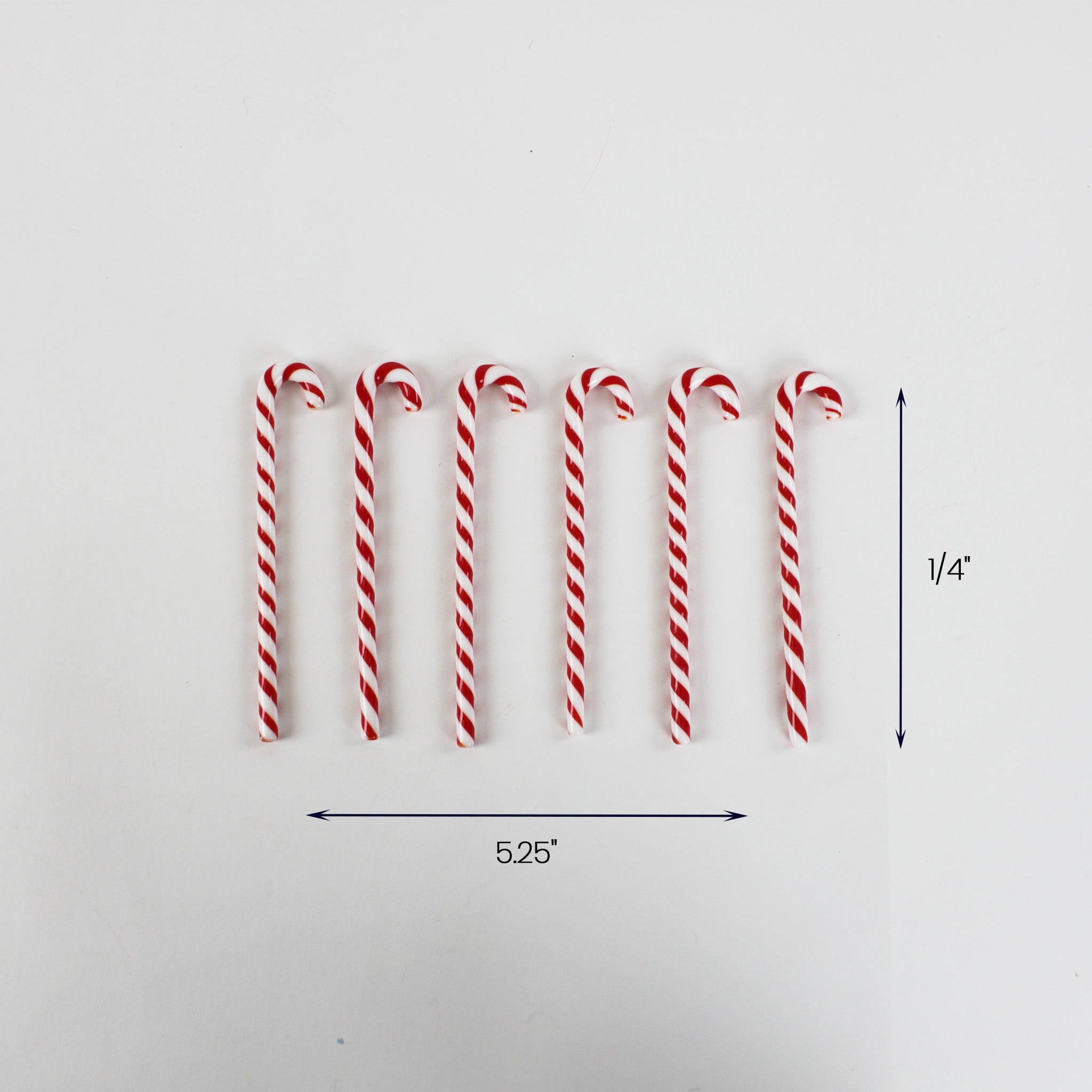 Set of seven red and white striped candy cane ornaments arranged in a row, each measuring approximately 5.25 inches long and 0.25 inches wide.