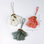 Three tassel ornaments in white, coral, and sage green with gold bead accents and hanging loops, displayed on a white background. Approximate size shown as 5.5 inches tall and 3 inches wide.