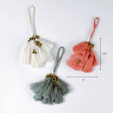 Three tassel ornaments in white, coral, and sage green with gold bead accents and hanging loops, displayed on a white background. Approximate size shown as 5.5 inches tall and 3 inches wide.