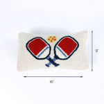 Rectangular hook pillow with red and blue pickleball paddles crossed at the center and a yellow ball above them, measuring 16 inches wide and 9 inches tall.