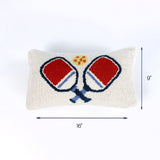 Rectangular hook pillow with red and blue pickleball paddles crossed at the center and a yellow ball above them, measuring 16 inches wide and 9 inches tall.