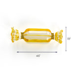 Yellow and clear glass candy ornament with gold glitter accents, measuring 4.5 inches wide and 1.5 inches tall.