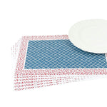 A stacked set of paper placemats featuring a blue trellis pattern with a red ditsy floral border beside a white plate.