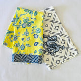 a yellow chinoiserie tea towel and a blue and white chinoiserie tea towel