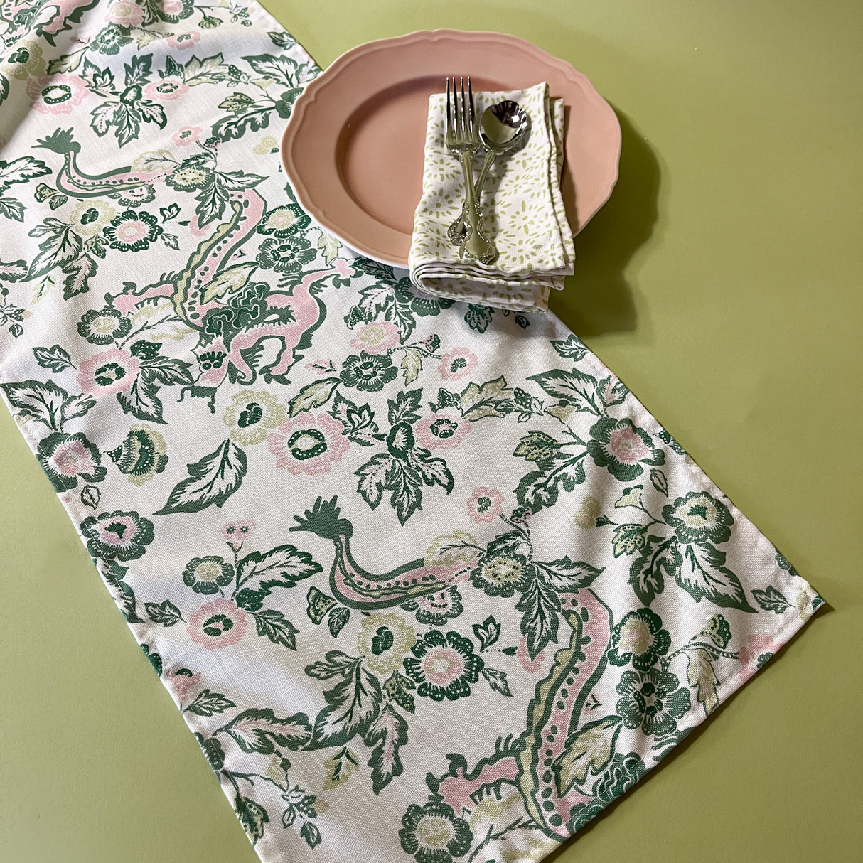 east of the sun chinoiserie cloth table runner with plate, dinner napkin and silverware