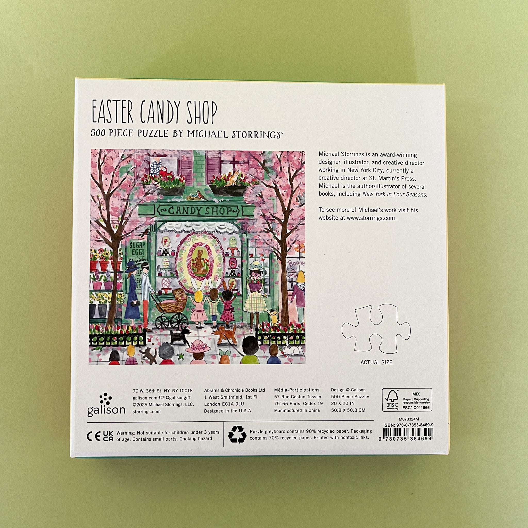 Illustrated 500-piece puzzle showing a colorful candy shop storefront with children and Easter decorations