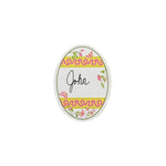 an egg-shaped spring paper place card designed by Madcap Cottage with a floral and ribbon design with the name John written in the center on a white background