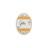 an egg-shaped spring paper place card designed by Madcap Cottage with a floral and ribbon design with the name John written in the center on a white background