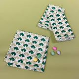 old jaipur green dinner napkins from madcap cottage with easter eggs on a green background. 