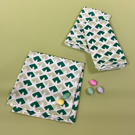 old jaipur green dinner napkins from madcap cottage with easter eggs on a green background. 