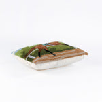 lying hooked wool derby day pillow featuring a brown race horse and hockey against a background of trees and blue sky