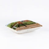 lying hooked wool derby day pillow featuring a brown race horse and hockey against a background of trees and blue sky