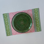 fez pink and green paper placemat with decorative pattern and green plate top view