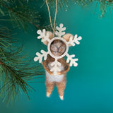 one felt mouse ornaments wearing white snowflake costume frame hanging from pine branches
