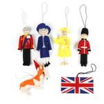 a set of 6 felt british royal family ornaments featuring king charles, queen camilla, queen elizabeth, a guard, a corgi and union jack flag. 