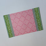 fez pink and green paper placemat with geometric pattern on white background