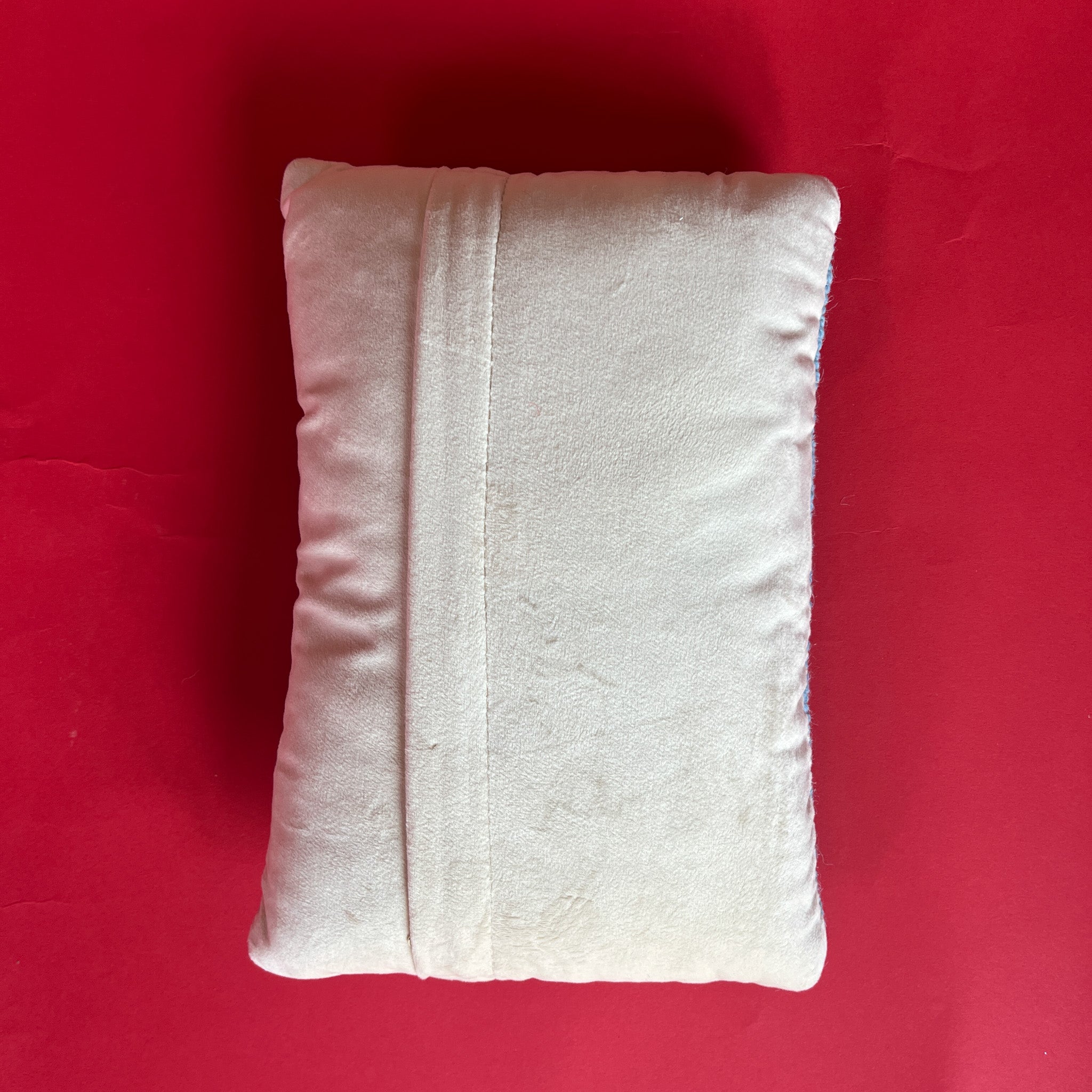 back of a Rectangular light blue pillow featuring a red, white, and blue Uncle Sam hat with stars bursting from the top, symbolizing a patriotic USA theme.