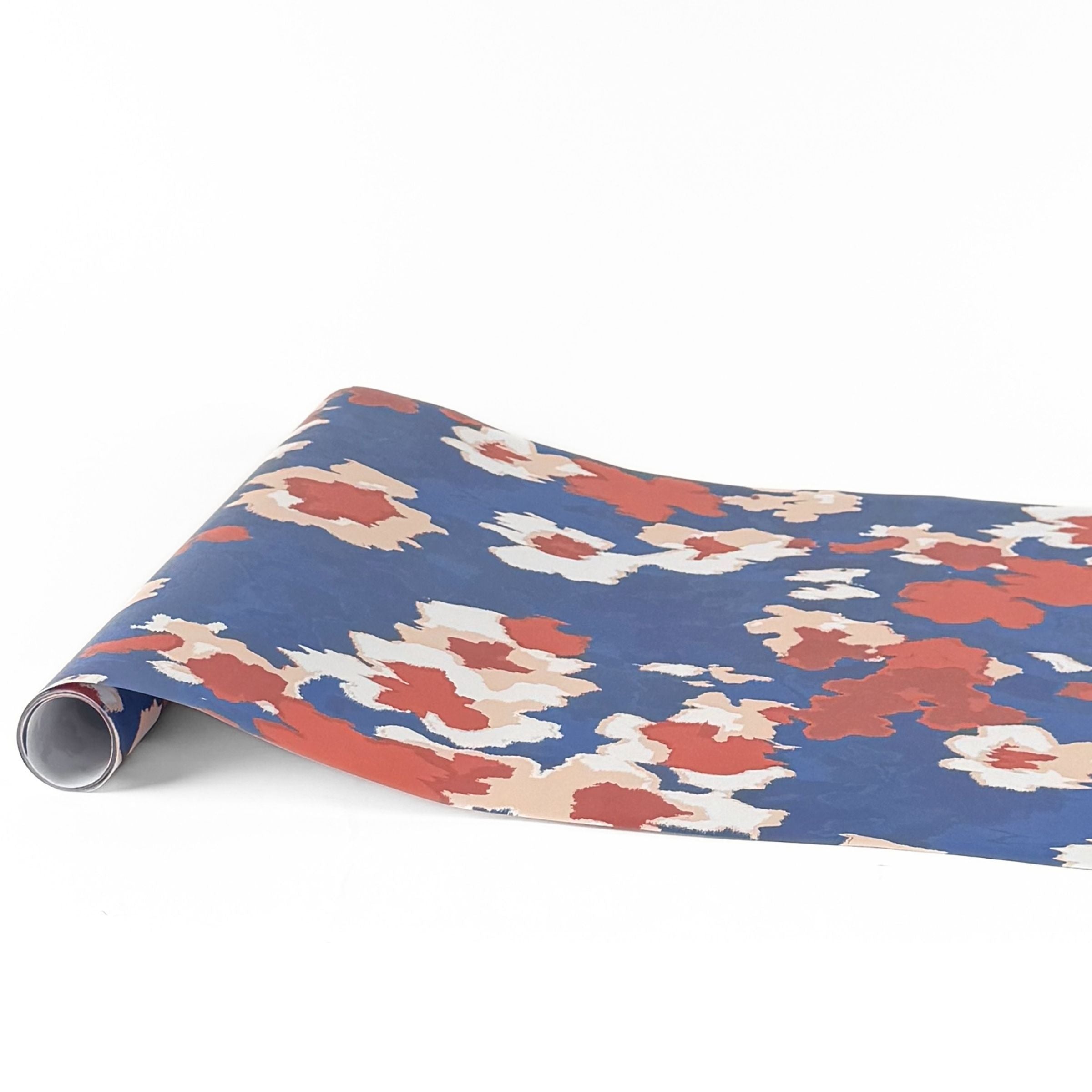 Floral blue red paper table runner with bold colorful floral pattern design.