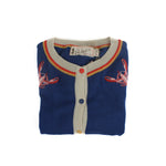 Folded blue knit cardigan with embroidered lobster motifs, contrast trim, and button front with branded label visible