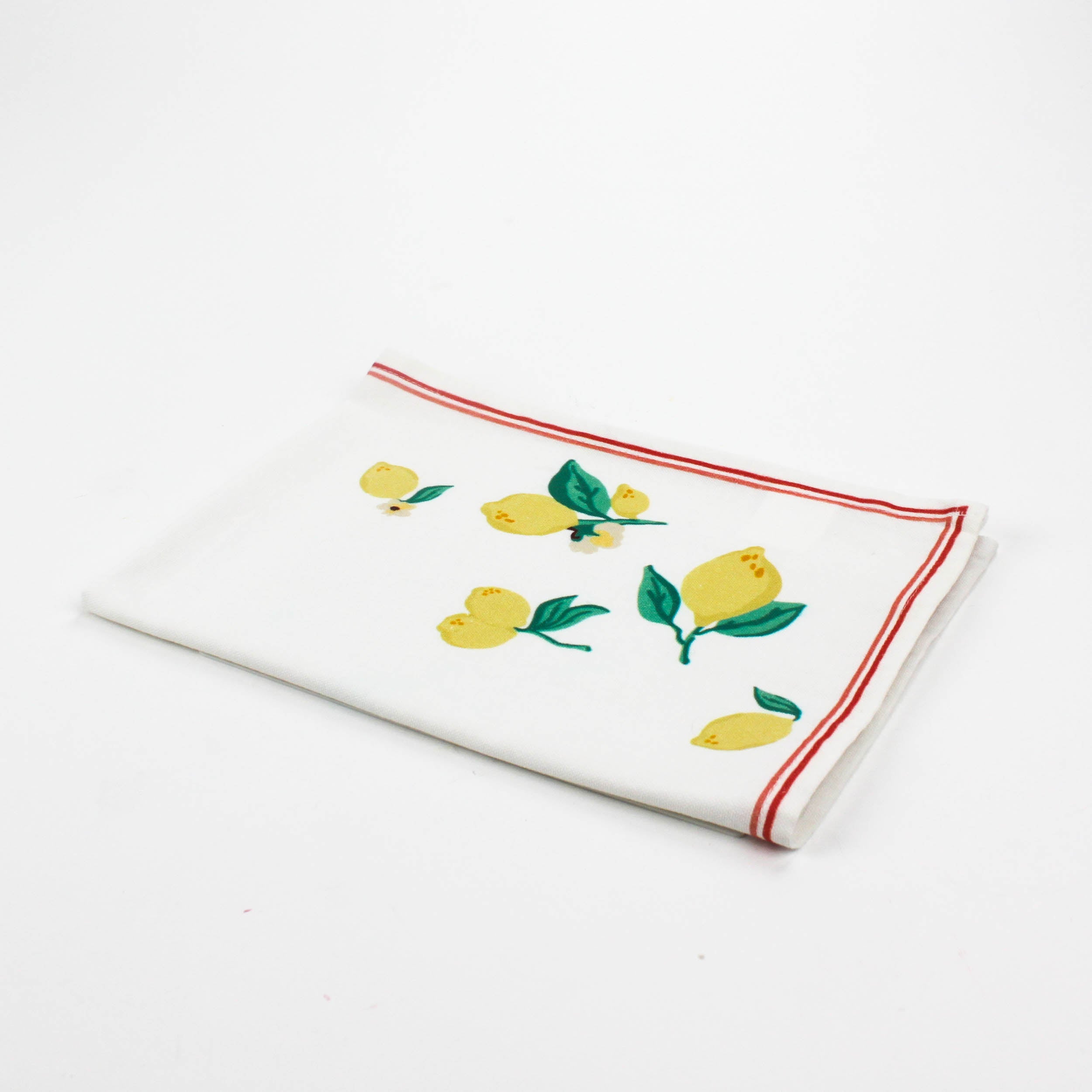 White Christmas tea towel decorated with yellow lemons and green leaves along the edges, bordered by a thin red outline