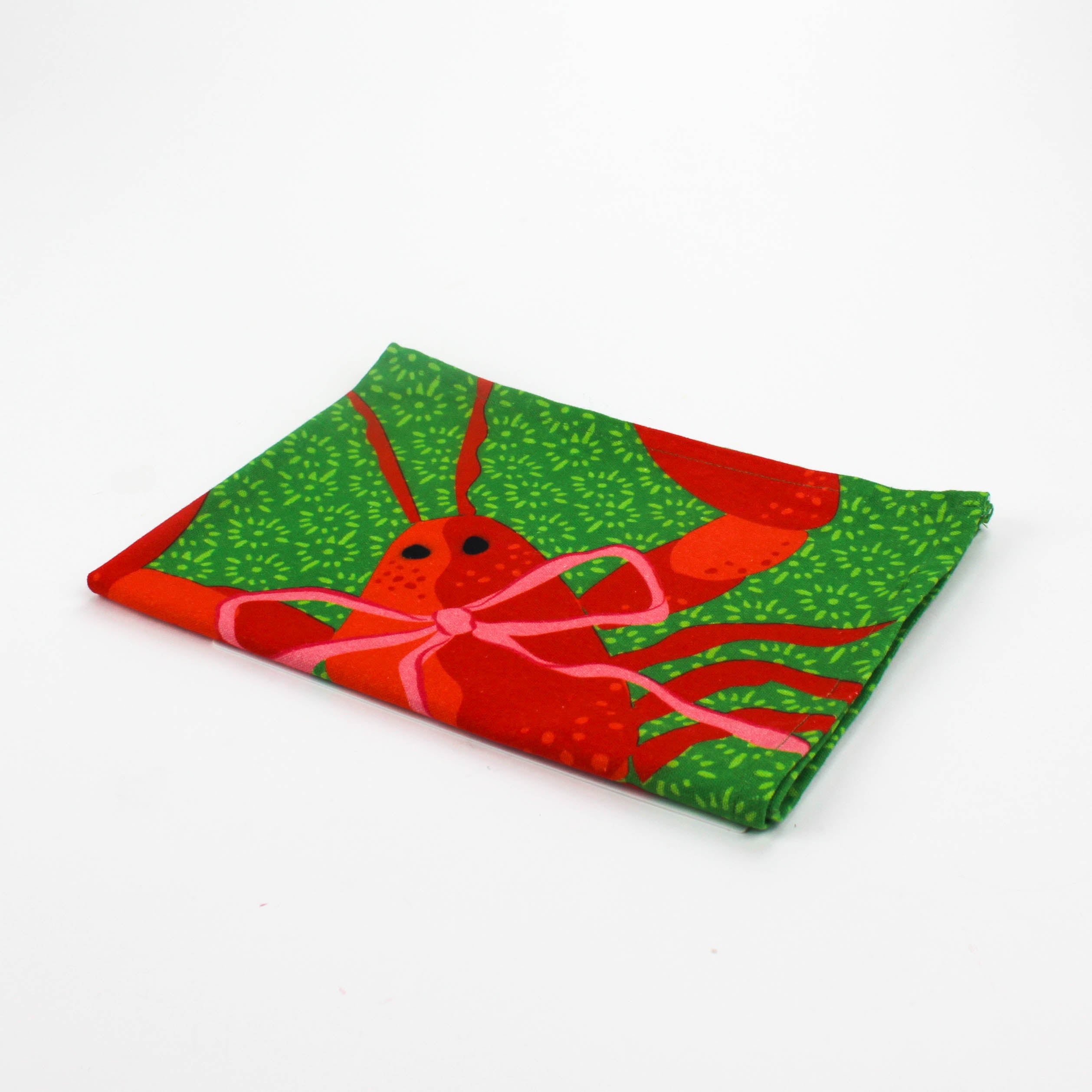 Green Christmas tea towel with a festive red lobster illustration tied with a pink bow